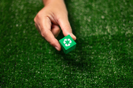 Wooden cube featuring a green net design represents sustainable business practices, encouraging the eco-friendly recycling of resources to protect Earth's ecology. recycle, eco, earth, ecology, net.の写真素材