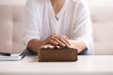 Christian woman with faith and hope, raises her hand in worship to pray to God and Jesus Christ, embodying her religion. woman, hand, faith, pray, worship, jesus christ, christian, god, hope.の写真素材