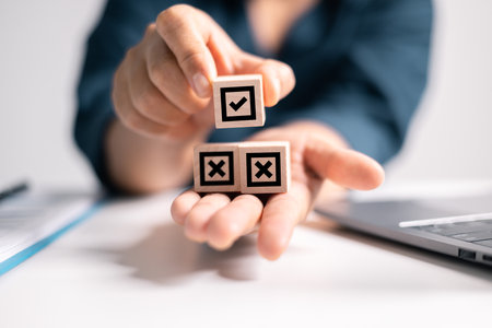 Wooden cube with an OK mark symbolizes approved choices in business, representing correctness and acceptance in decision-making. approved, wooden, cube, ok, correct, accept, business, agree, approvalの写真素材