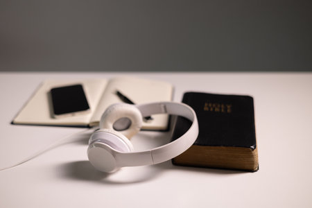 Reading the Holy Bible on a cellular device showcases how technology integrates with Christian practices, making the sacred book accessible beyond paper in both personal and business contexts.の写真素材