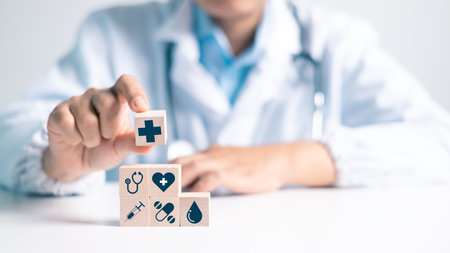 Wooden blocks arranged to health care represent the concept of medicine and critical role doctors play in combating disease in field of medical care. health, care, wooden, block, disease, medicals.の写真素材