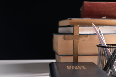 Old library, an open Bible lay on the table, its holy pages of scripture illuminated in the dark room. bible, holy, dark, old, open, library, pages, scripture, table, book, page.の写真素材