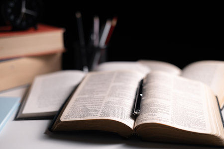Old library, an open Bible lay on the table, its holy pages of scripture illuminated in the dark...