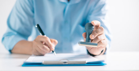 Notary placed their stamp of approval on the document as the lawyer and business person finalized...