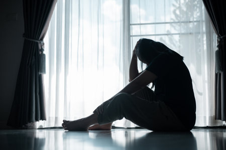 young woman sat alone, feeling weight of anxiety, stress, and depression, her sadness echoing struggles many people face in silence. anxiety, stress, depression, woman, person, sad, adult, alone.の写真素材