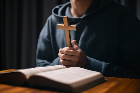Person raised their hand in prayer at the church, embodying their Christian faith and belief in God, seeking hope and the holy presence of Christ through their devout religion. jesus christ, pray.の写真素材
