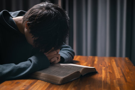 Person raised their hand in prayer at the church, embodying their Christian faith and belief in God, seeking hope and the holy presence of Christ through their devout religion. jesus christ, pray.の写真素材