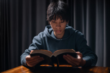 Person raised their hand in prayer at the church, embodying their Christian faith and belief in God, seeking hope and the holy presence of Christ through their devout religion. jesus christ, pray.の写真素材