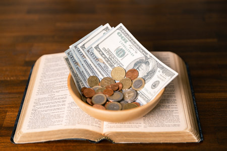 Idea of giving tithe as an offering to charity filled him with hope and peace, as he donated money with faith in making positive impact. book, financial, believe, spiritual, currency, wealth, coinの写真素材