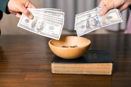 He decided to donate portion of his earnings as tithe, giving money and coins as contribution to support financial needs of community. beg, quest, request, desire, need, problem, share, charitableの写真素材