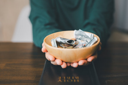 He decided to donate portion of his earnings as tithe, giving money and coins as contribution to...