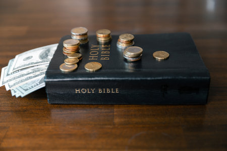 Idea of giving tithe as an offering to charity filled him with hope and peace, as he donated money with faith in making positive impact. book, financial, believe, spiritual, currency, wealth, coinの写真素材