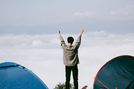 Man traveler with camera backpack hiking outdoor travel lifestyle and adventure concept. cap backpack and join of tourist for green mountain tour, beauty of nature and expansive sky people of tourismの写真素材