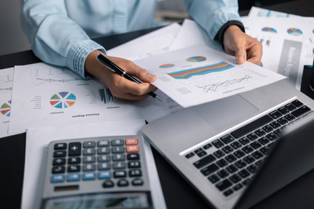 Finance bank tax expense accounting budget money businessman hand use calculator Financial calculate accountant close up calculator with graph chart write office desk Business expense analysis savingの写真素材