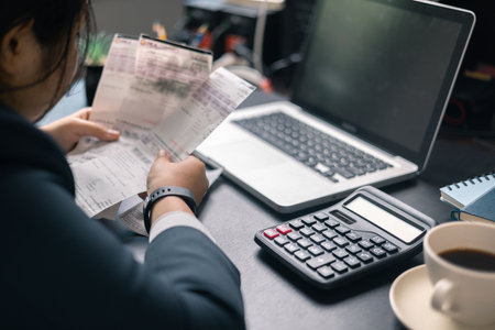 Finance bank tax expense accounting budget money businessman hand use calculator Financial calculate accountant close up calculator with graph chart write office desk Business expense analysis savingの写真素材
