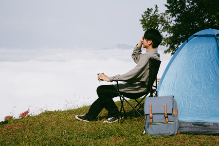 Man traveler with camera backpack hiking outdoor travel lifestyle and adventure concept. cap backpack and join of tourist for green mountain tour, beauty of nature and expansive sky people of tourismの写真素材