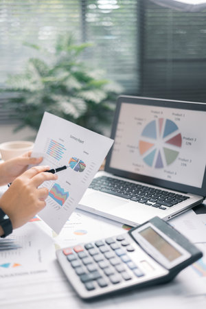 Finance bank tax expense accounting budget money businessman hand use calculator Financial calculate accountant close up calculator with graph chart write office desk Business expense analysis savingの写真素材
