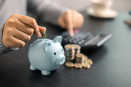 Finance bank tax expense accounting budget money businessman hand use calculator Financial calculate accountant close up calculator with graph chart write office desk Business expense analysis savingの写真素材