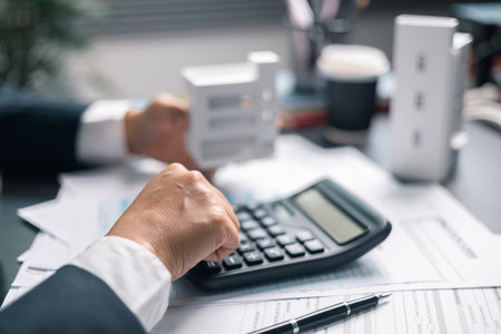 Finance bank tax expense accounting budget money businessman home for Business expense analysis saving use Financial calculate accountant close up calculator with graph chart hand write office deskの写真素材