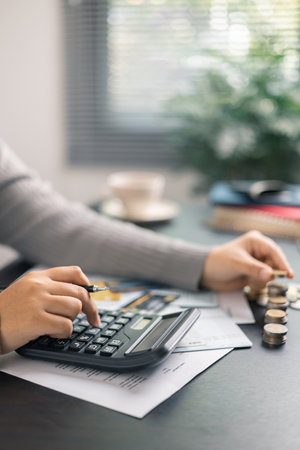 Finance bank tax expense accounting budget money businessman hand use calculator Financial calculate accountant close up calculator with graph chart write office desk Business expense analysis savingの写真素材