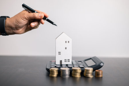 Finance bank tax expense accounting budget money businessman home for Business expense analysis saving use Financial calculate accountant close up calculator with graph chart hand write office deskの写真素材