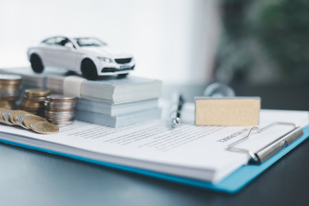 Approved car loan application with car key, rubber stamp and calculator concept. financial document on wooden table. Asset approval purchases to buy car. Ideas for car buying checklist loan taxの写真素材