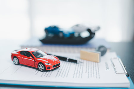 Approved car loan application with car key, rubber stamp and calculator concept. financial document on wooden table. Asset approval purchases to buy car. Ideas for car buying checklist loan taxの写真素材