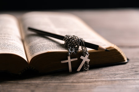 Religious belief concept Close up prayer Christian church service Bible Holy cross Spiritual power Blurred background Desk copy space Heaven God Catholic faith Praise book Jesus worship Gospel symbolsの写真素材