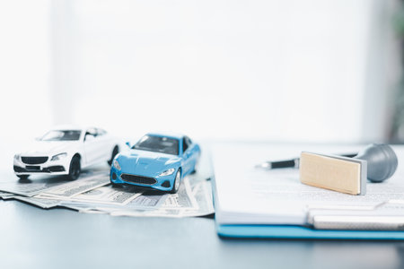 Approved car loan application with car key, rubber stamp and calculator concept. financial document on wooden table. Asset approval purchases to buy car. Ideas for car buying checklist loan taxの写真素材