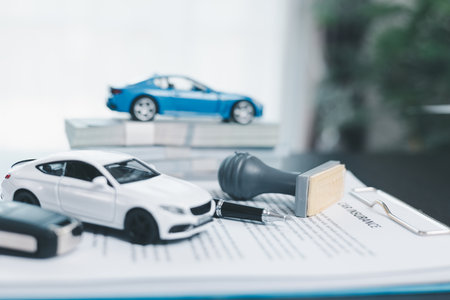 Approved car loan application with car key, rubber stamp and calculator concept. financial document on wooden table. Asset approval purchases to buy car. Ideas for car buying checklist loan taxの写真素材