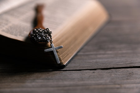 Religious belief concept Close up prayer Christian church service Bible Holy cross Spiritual power Blurred background Desk copy space Heaven God Catholic faith Praise book Jesus worship Gospel symbolsの写真素材