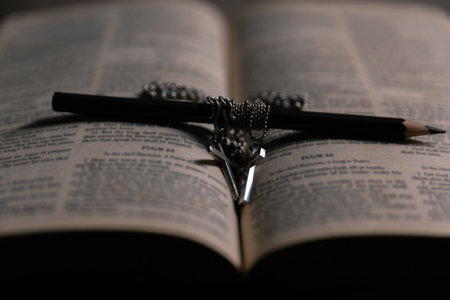 Religious belief concept Close up prayer Christian church service Bible Holy cross Spiritual power Blurred background Desk copy space Heaven God Catholic faith Praise book Jesus worship Gospel symbolsの写真素材