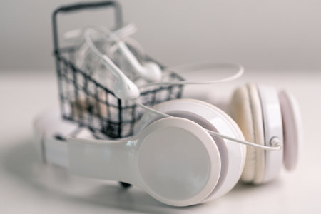 New technology modern Close up high resolution Wireless Earphones white Earbuds headphones black blur background Trendy minimal music device laptop concept phone accessories Comfortable Wooden tableの写真素材