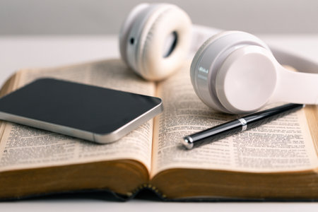 Close-up religious technology headphones pray bible church laptop Jesus Christ Holy Spirit Sunday service spiritual power blur background phone concept heaven belief gospel faith praise worship godの写真素材