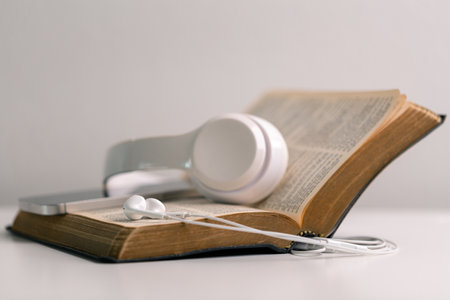 Close-up religious technology headphones pray bible church laptop Jesus Christ Holy Spirit Sunday service spiritual power blur background phone concept heaven belief gospel faith praise worship godの写真素材