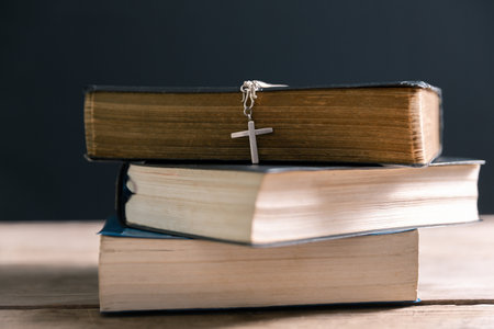 Religious belief concept Close up prayer Christian church service Bible Holy cross Spiritual power Blurred background Desk copy space Heaven God Catholic faith Praise book Jesus worship Gospel symbolsの写真素材