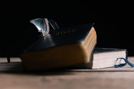 Religious belief concept Close up prayer Christian church service Bible Holy cross Spiritual power Blurred background Desk copy space Heaven God Catholic faith Praise book Jesus worship Gospel symbolsの写真素材