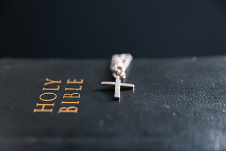 Religious belief concept Close up prayer Christian church service Bible Holy cross Spiritual power Blurred background Desk copy space Heaven God Catholic faith Praise book Jesus worship Gospel symbolsの写真素材