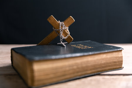 Religious belief concept Close up prayer Christian church service Bible Holy cross Spiritual power Blurred background Desk copy space Heaven God Catholic faith Praise book Jesus worship Gospel symbolsの写真素材