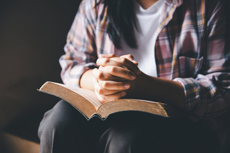 Christian woman reading bible. Reading Holy Bible. Concept for faith, spirituality and religion. Peace, hope, Christians with holy book for worship and faithの写真素材