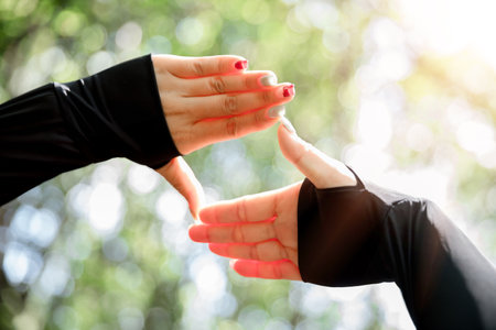 Young woman hand reaching for mountains. Spiritual girl smiling to sky. Happy female being thankful. Spiritual girl praying with hope. Positive asian young woman feeling hope and faith looking up.の写真素材