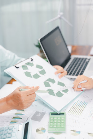 Business people working on sustainable innovation project. renewable energy concept. Teamwork Meeting, partner on model building company office technology, based green businesses and global warming.の写真素材