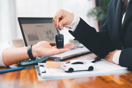 à¸ºBusinessman approval stamper stamp on paper business contract. car loan money approved. Dealer or manager gives car to customer sign car purchase document with insurance, contract to buy car legal.の写真素材