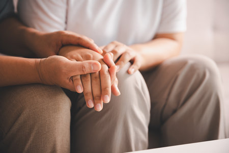 Hope and trust with crisis concept. Closeup, love and holding hands for support, comfort and care with grief, loss and empathy. People and family with compassion, sympathy and healing with bonding.の写真素材