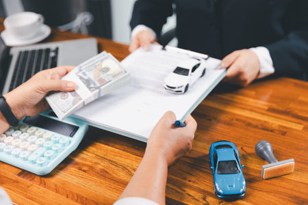 à¸ºBusinessman approval stamper stamp on paper business contract. car loan money approved. Dealer or manager gives car to customer sign car purchase document with insurance, contract to buy car legal.の写真素材