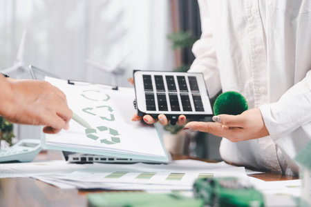 Business people working on sustainable innovation project. renewable energy concept. Teamwork Meeting, partner on model building company office technology, based green businesses and global warming.の写真素材