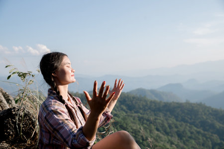 Grateful woman having HOPE. Spiritual girl smiling to sky. Happy female being thankful. Spiritual girl praying with hope. Positive Asian young woman feeling hope and faith looking up.の写真素材