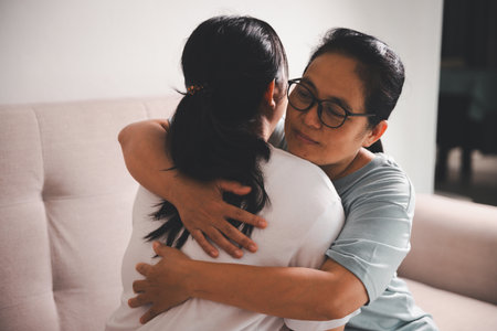 Hope and trust with crisis concept. Closeup, love and holding hands for support, comfort and care with grief, loss and empathy. people and family with compassion, sympathy and healing with bonding.の写真素材