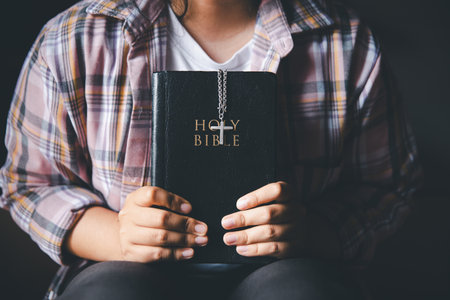 Person reading a Bible. Concept for faith, spirituality and religion. Peace, hope, people with holy book for worship and faithの写真素材