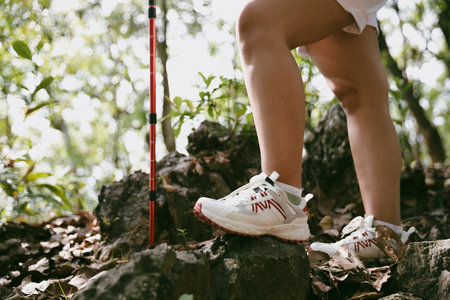 Hiking action on mountain grass trail path. Close up of female hiker shoe. adventurous lifestyle of...